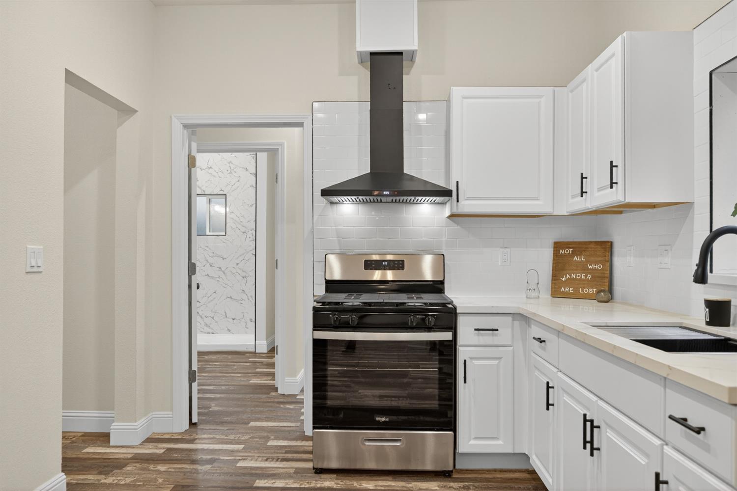 400 Pacific Lodi, CA 95242 - Photo 29 of 50 a kitchen with white cabinets and appliances