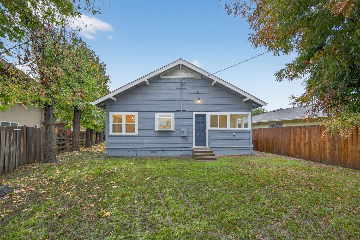 400 Pacific Lodi, CA 95242 - Photo 43 of 50 a house that is sitting in the grass with wooden fence