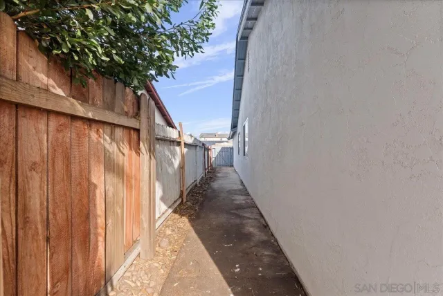 a view of a pathway of a wooden fence