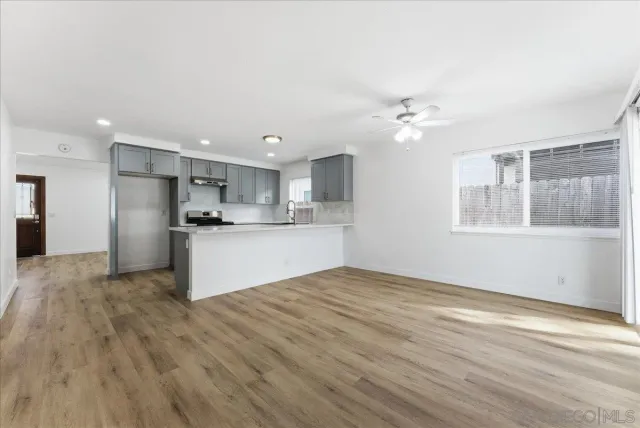 a view of kitchen with wooden floor and window