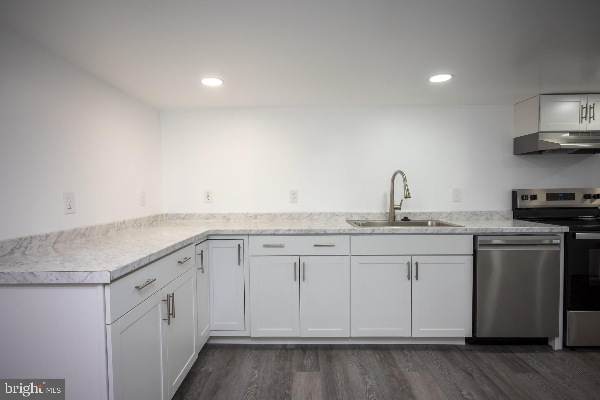 2104 Steuben Way Silver Spring, MD 20905 - Photo 17 of 25 a kitchen with white cabinets appliances and sink