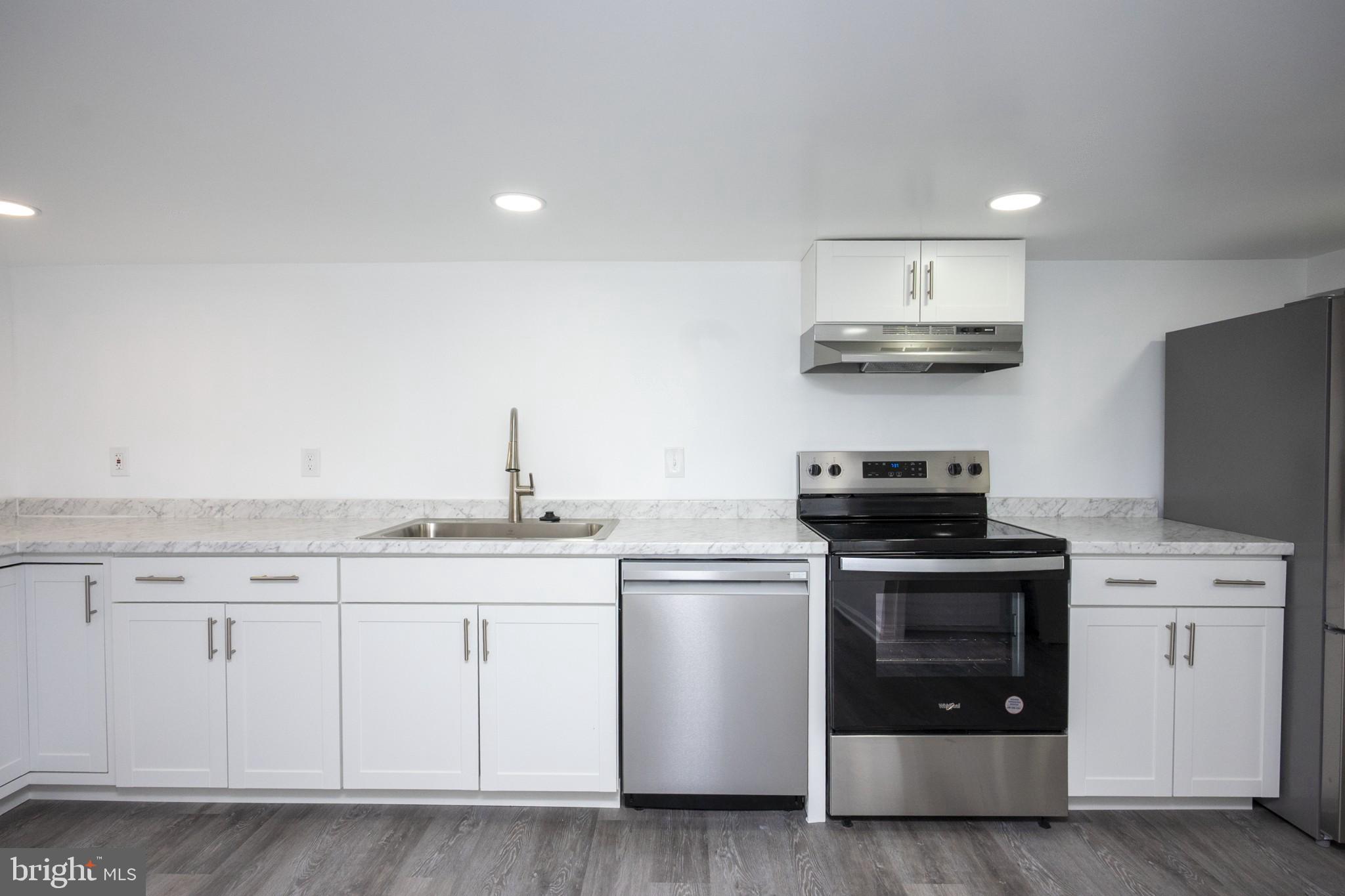 2104 Steuben Way Silver Spring, MD 20905 - Photo 18 of 25 a kitchen with stainless steel appliances a sink and a stove