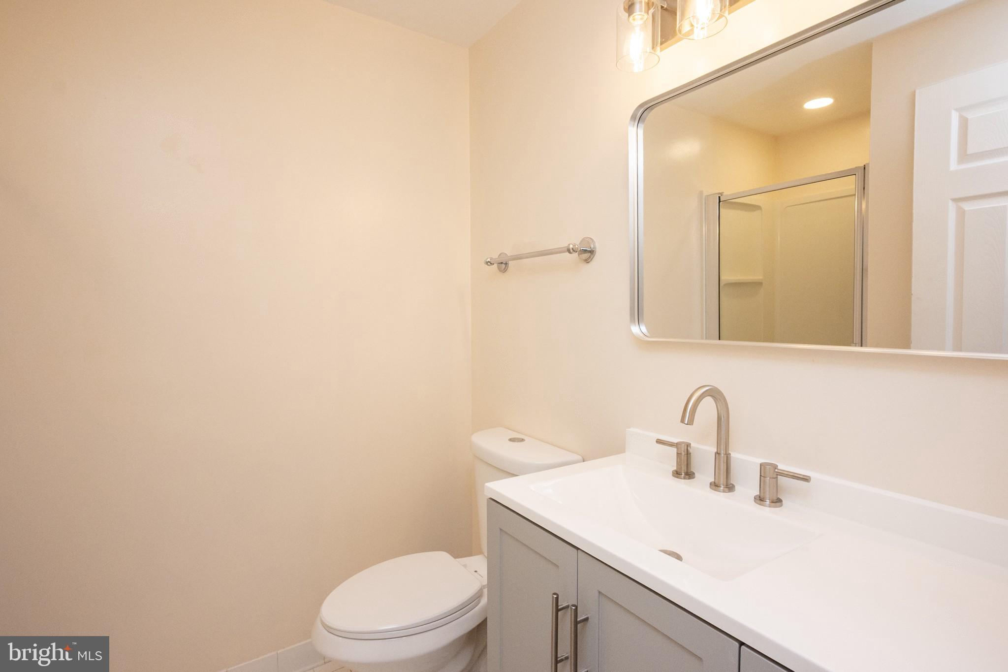 2104 Steuben Way Silver Spring, MD 20905 - Photo 21 of 25 a bathroom with a sink a toilet and mirror