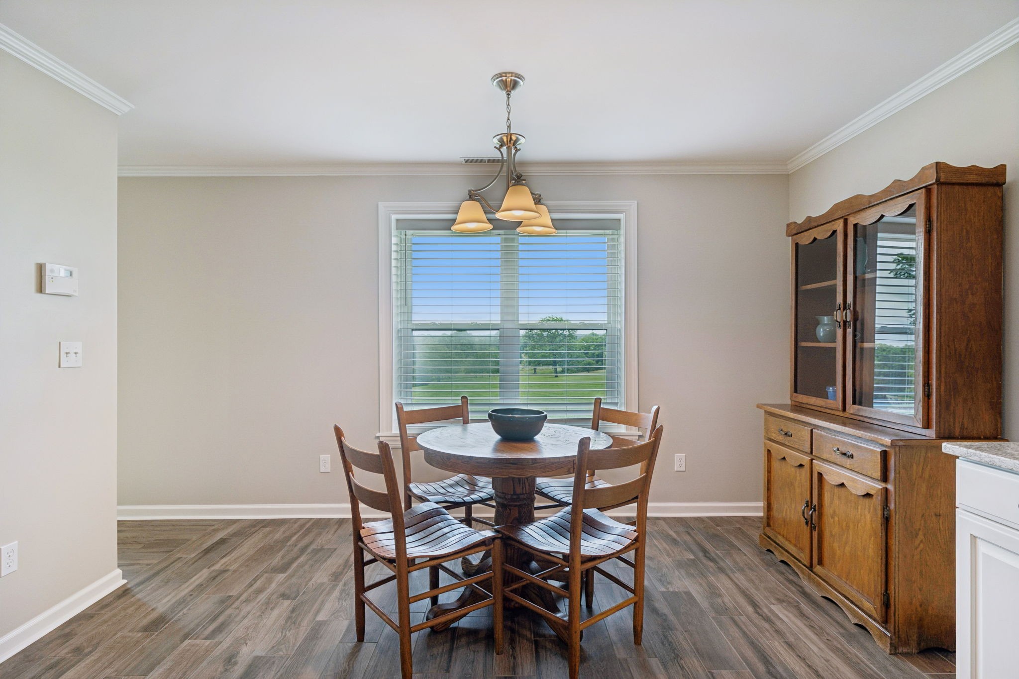 1731 Hudson Road Madison, TN 37115 - Photo 47 of 75 a dining room with wooden floor a chandelier a glass table and chairs