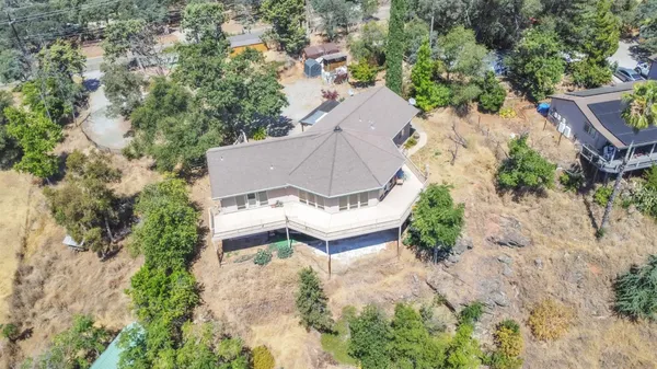 an aerial view of a house with a yard
