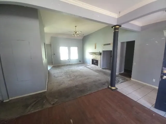 a spacious bedroom with a bed and a mirror