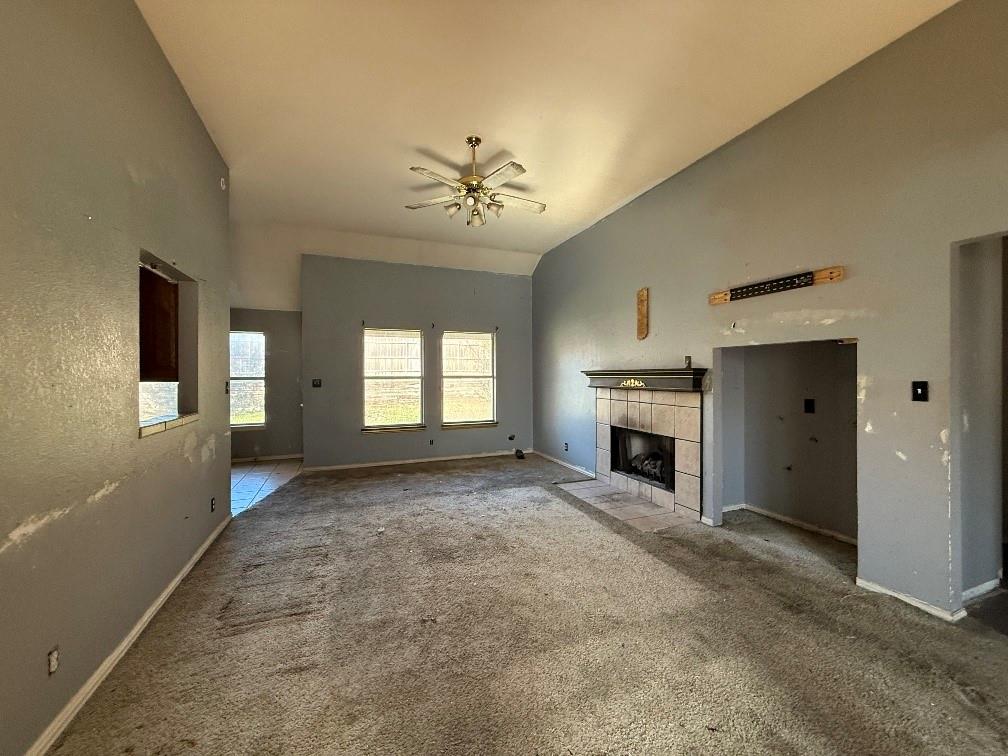 5424 Appalachian Way Fort Worth, TX 76123 - Photo 3 of 16 a view of a livingroom with a fireplace chandelier a ceiling fan and windows