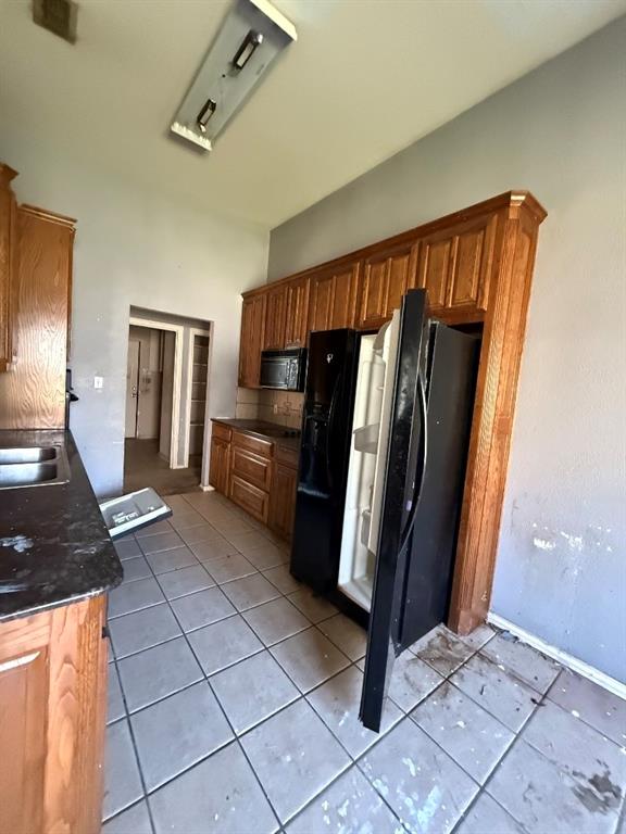 5424 Appalachian Way Fort Worth, TX 76123 - Photo 6 of 16 a kitchen with granite countertop a refrigerator and a stove