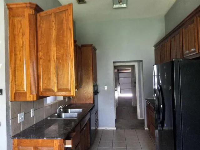 a bathroom with double vanity and a bathtub