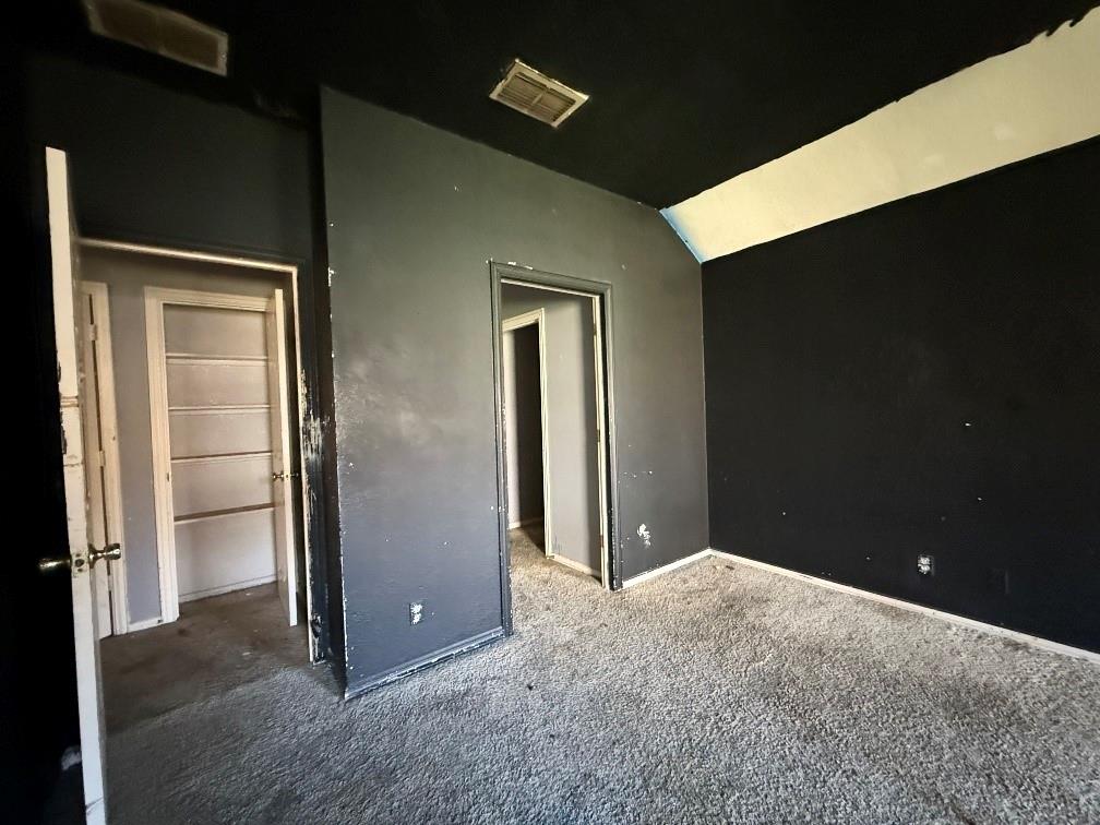 5424 Appalachian Way Fort Worth, TX 76123 - Photo 7 of 16 an empty room with closet and wooden door