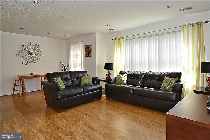 14201 Woolen Oak Court, Unit 432 Silver Spring, MD 20906 - Photo 2 of 20 a living room with furniture and window