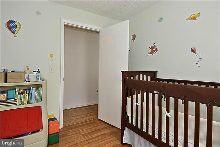 14201 Woolen Oak Court, Unit 432 Silver Spring, MD 20906 - Photo 13 of 20 a view of a hallway with wooden floor and closet