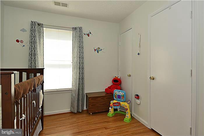 14201 Woolen Oak Court, Unit 432 Silver Spring, MD 20906 - Photo 14 of 20 a children room with wooden floor and a window