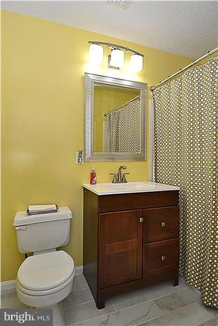 14201 Woolen Oak Court, Unit 432 Silver Spring, MD 20906 - Photo 15 of 20 a bathroom with a toilet sink and mirror