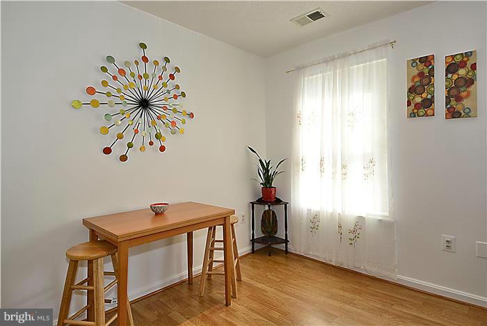 14201 Woolen Oak Court, Unit 432 Silver Spring, MD 20906 - Photo 4 of 20 a view of a workspace with furniture and a window