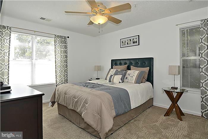14201 Woolen Oak Court, Unit 432 Silver Spring, MD 20906 - Photo 9 of 20 a bedroom with a bed and a window