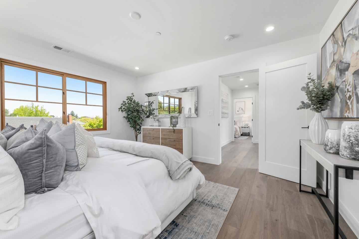 1151 Rosedale Avenue Burlingame, CA 94010 - Photo 28 of 38 a spacious bedroom with a large bed and a chandelier