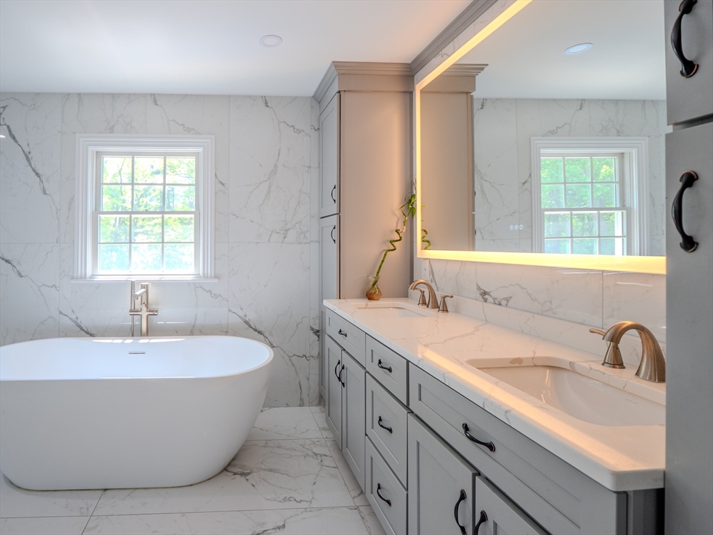 159 Mishawum Road Woburn, MA 01801 - Photo 14 of 41 a spacious bathroom with a granite countertop sink and a bathtub
