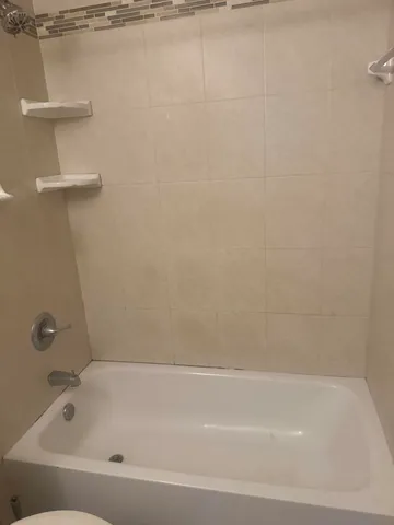 a bathroom with a shower and a bathtub