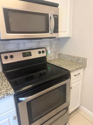 a stove top oven sitting inside of a kitchen