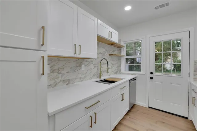 a kitchen with a sink and cabinets
