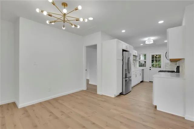 a view of a kitchen with a sink and a refrigerator
