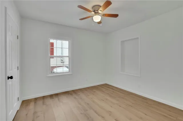 wooden floor in an empty room with a window