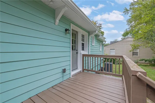 a balcony with wooden floor and fence