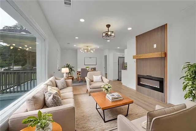 a living room with furniture and a wooden floor