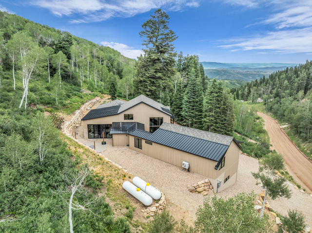 1766 West Tollgate Cyn Road Coalville, UT 84017 - Photo 46 of 59 Modern mountain residence featuring a light-toned exterior siding and dark metal roofing