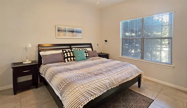 a bedroom with a large bed and a window