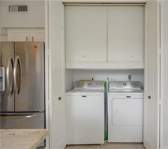 a kitchen with a refrigerator sink and cabinets