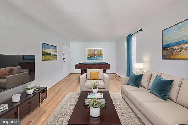 a living room with furniture and painting on the wall