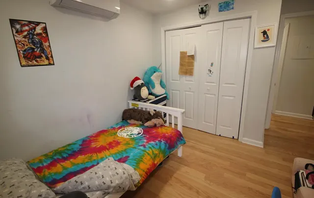 a bedroom with a bed and a dresser