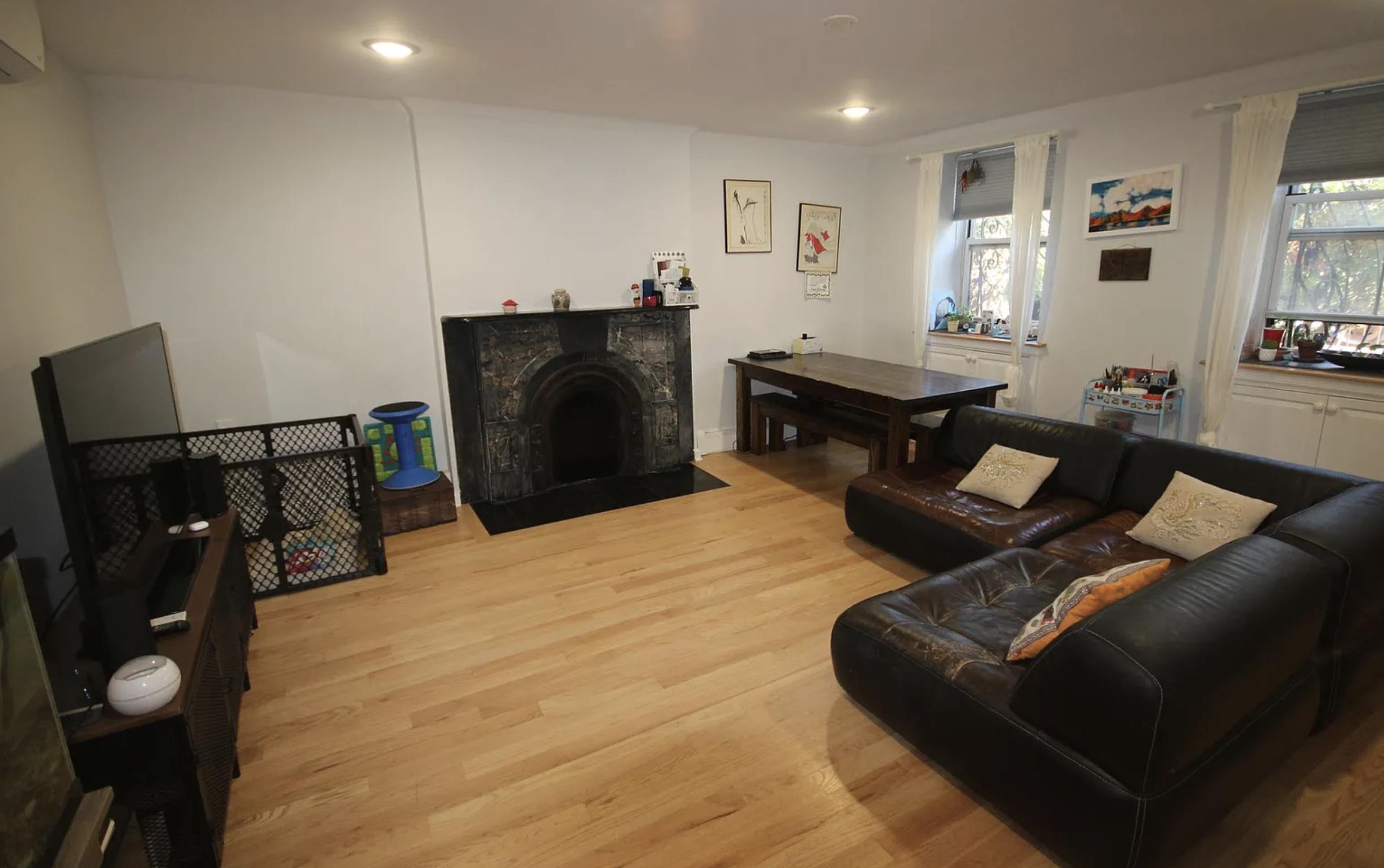 422 Hudson Street, Unit 1 Hoboken, NJ 07030 - Photo 4 of 18 a living room with furniture a flat screen tv and a refrigerator