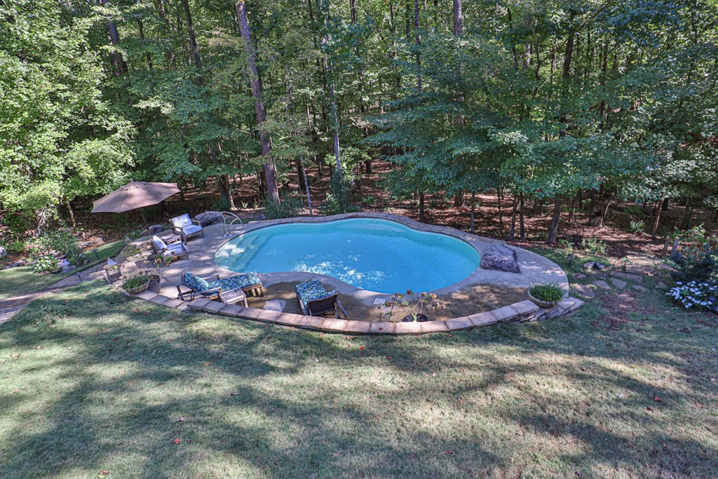 40 Maple Court Midland, GA 31820 - Photo 26 of 38 Saltwater pool with stone retaining wall