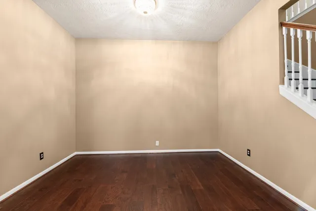 a view of a small space with wooden floor and a window