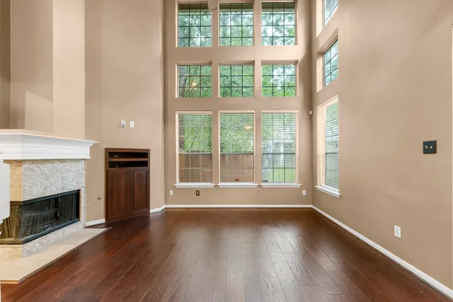 a view of room with window and wooden floor