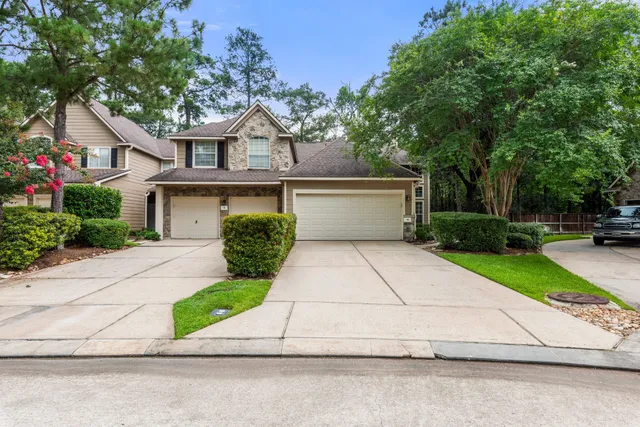 a front view of a house with a yard and a garage