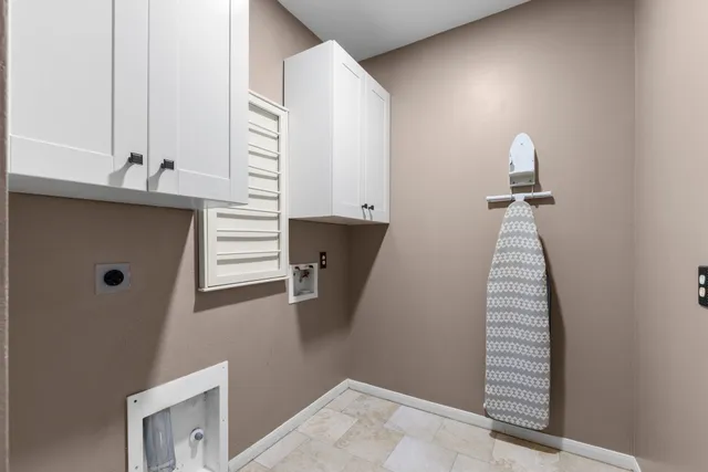 a view of stairs and an empty room with windows