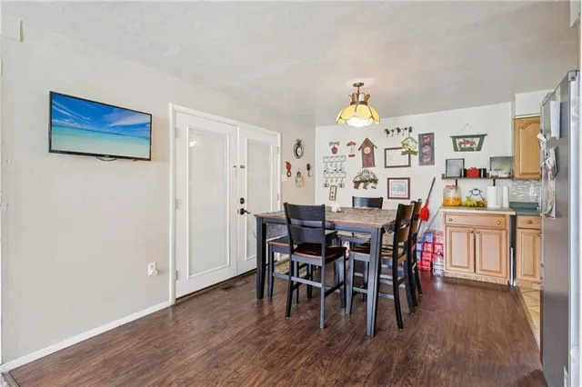 a dining room with furniture a chandelier and wooden floor