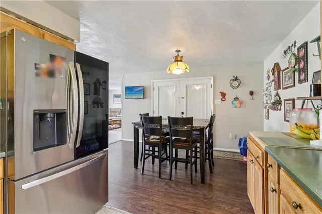 a view of a dining room with furniture and a window