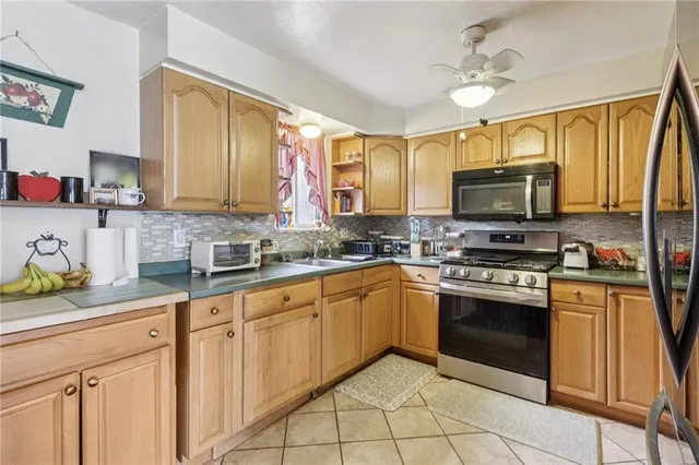 a kitchen with stainless steel appliances granite countertop a stove sink and microwave