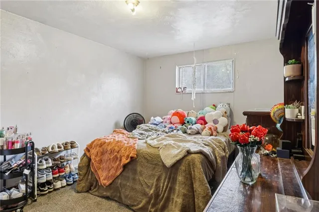 a bedroom with bed and a window