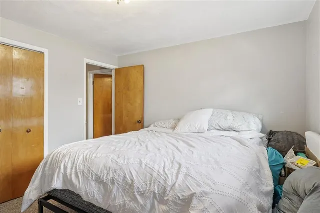 a bedroom with a bed and a closet