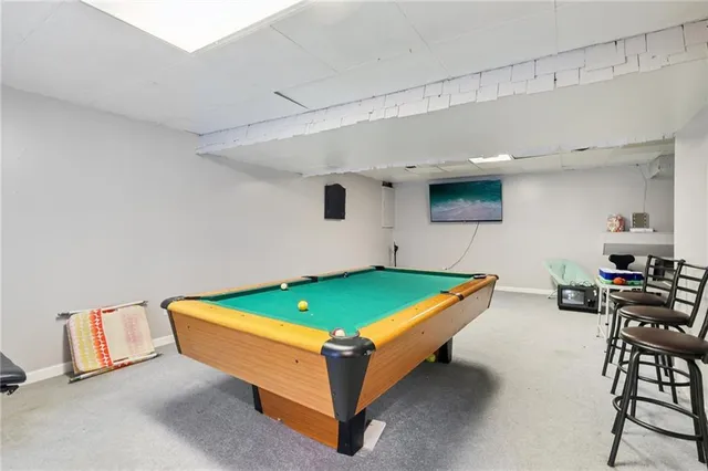 a room with furniture and pool table