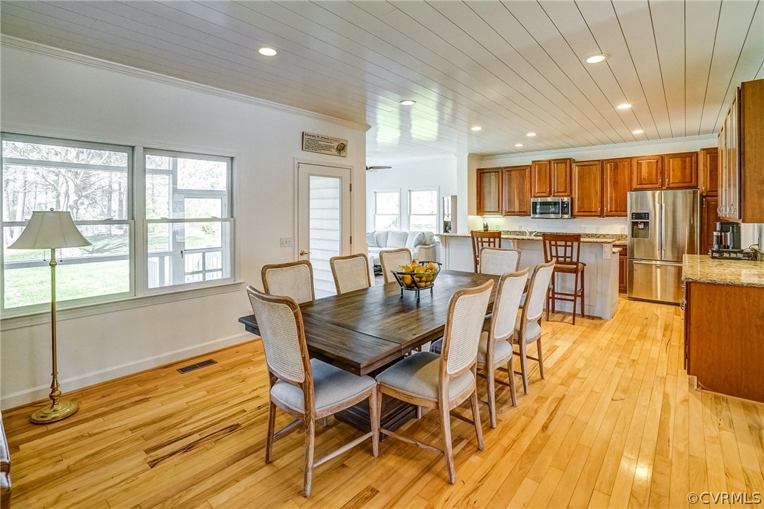 253 Prentice Point Drive Kilmarnock, VA 22482 - Photo 13 of 44 a view of a dining room with furniture and wooden floor