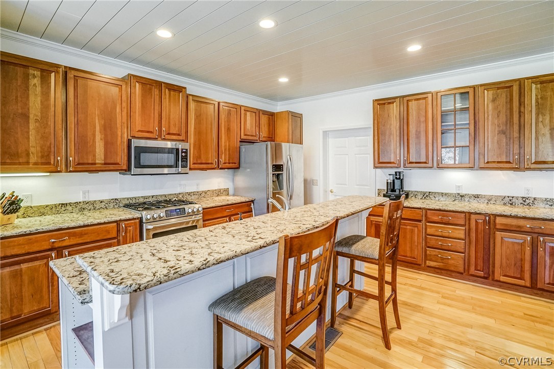 253 Prentice Point Drive Kilmarnock, VA 22482 - Photo 16 of 44 a kitchen with stainless steel appliances granite countertop wooden cabinets a stove top oven a sink and dishwasher