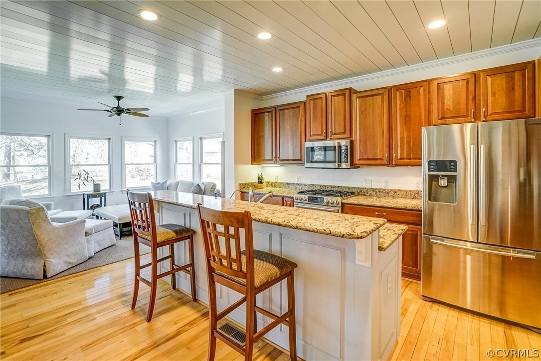 253 Prentice Point Drive Kilmarnock, VA 22482 - Photo 17 of 44 a kitchen with stainless steel appliances granite countertop a refrigerator a sink dishwasher and a stove with wooden floor