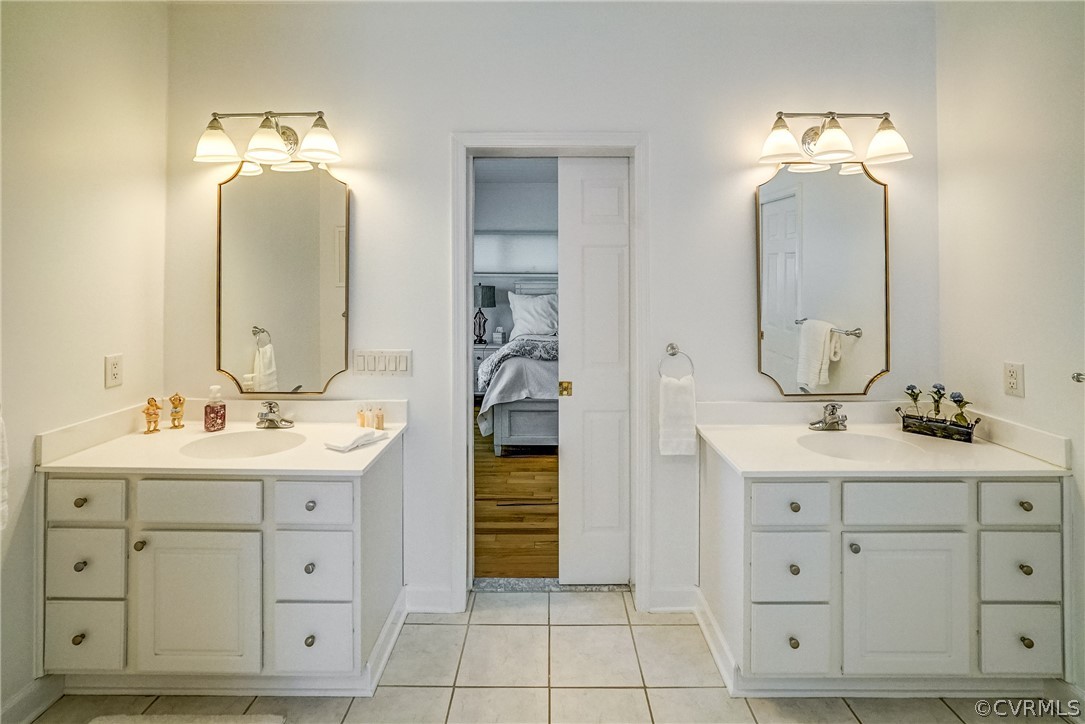 253 Prentice Point Drive Kilmarnock, VA 22482 - Photo 23 of 44 a bathroom with a double vanity sink and a mirror